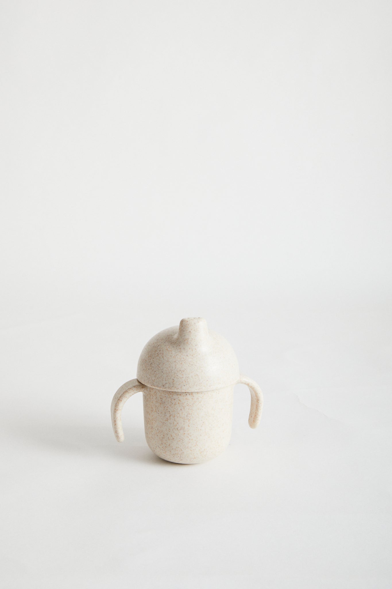 Wheat Straw Sippy Cup in Oat. White screw top lid, sappy spout and handles.