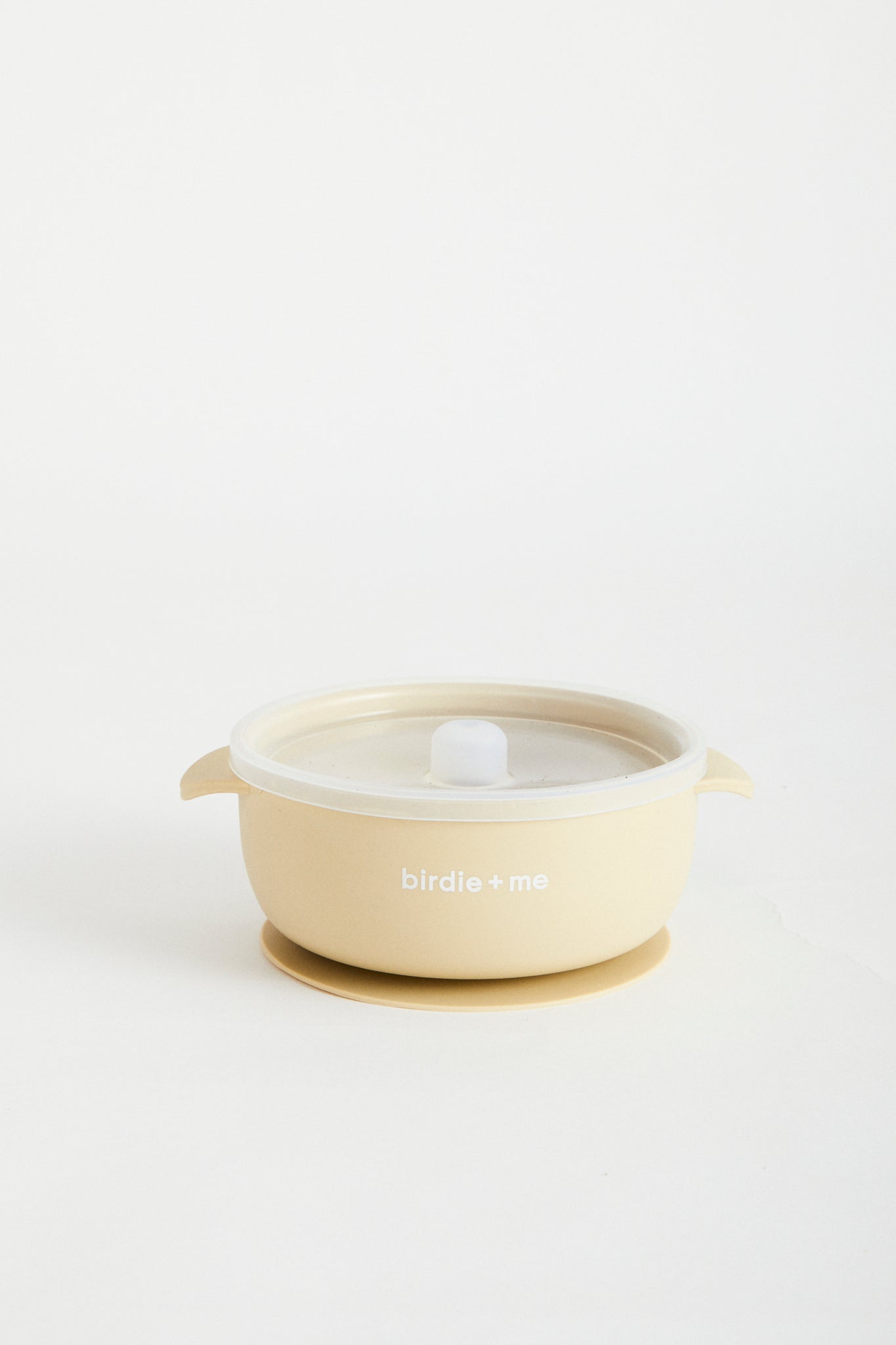 Silicone bowl with suction bottom and lid. Branded with birdie + me logo.