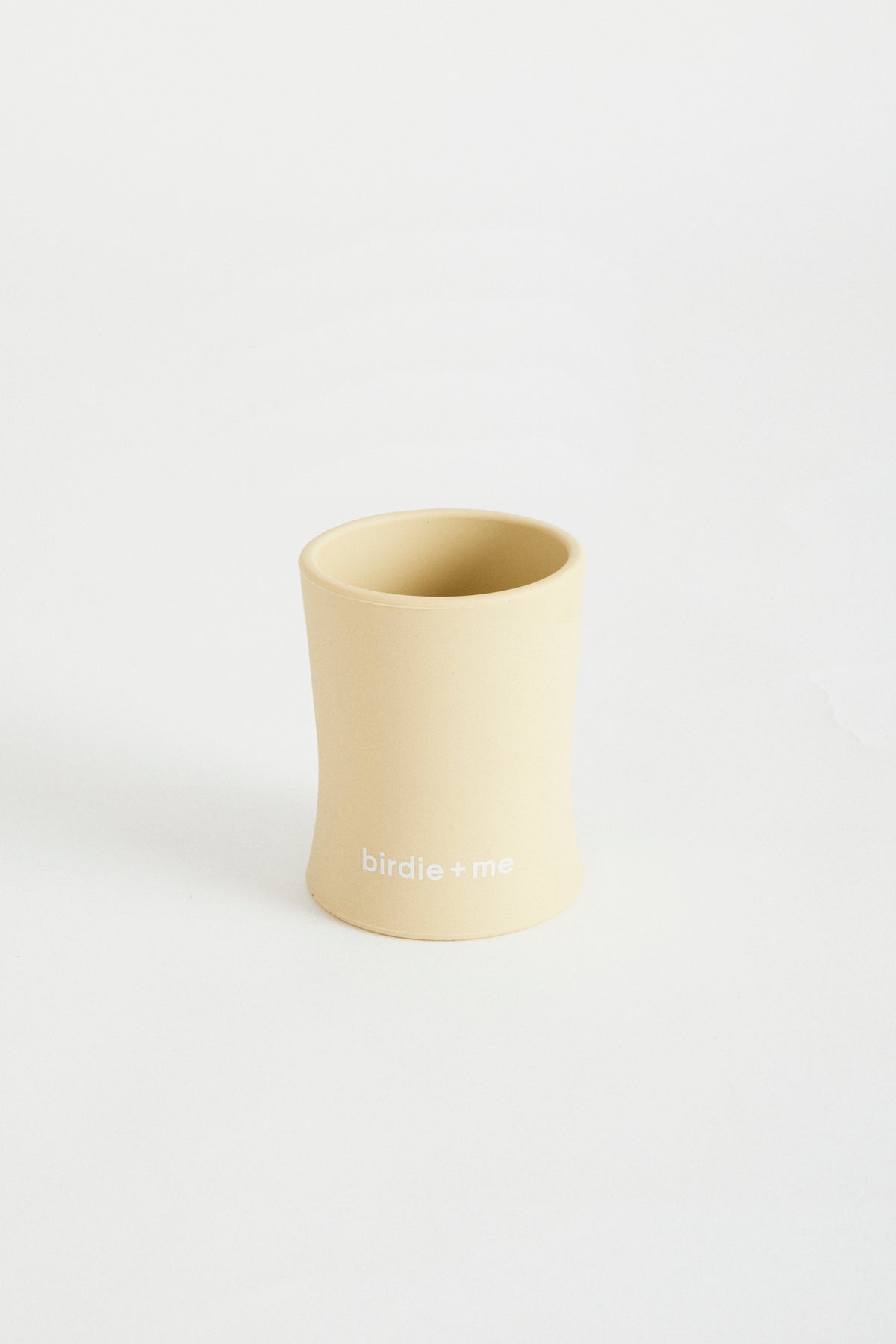Silicone cup in Honey, birdie + me logo along bottom.