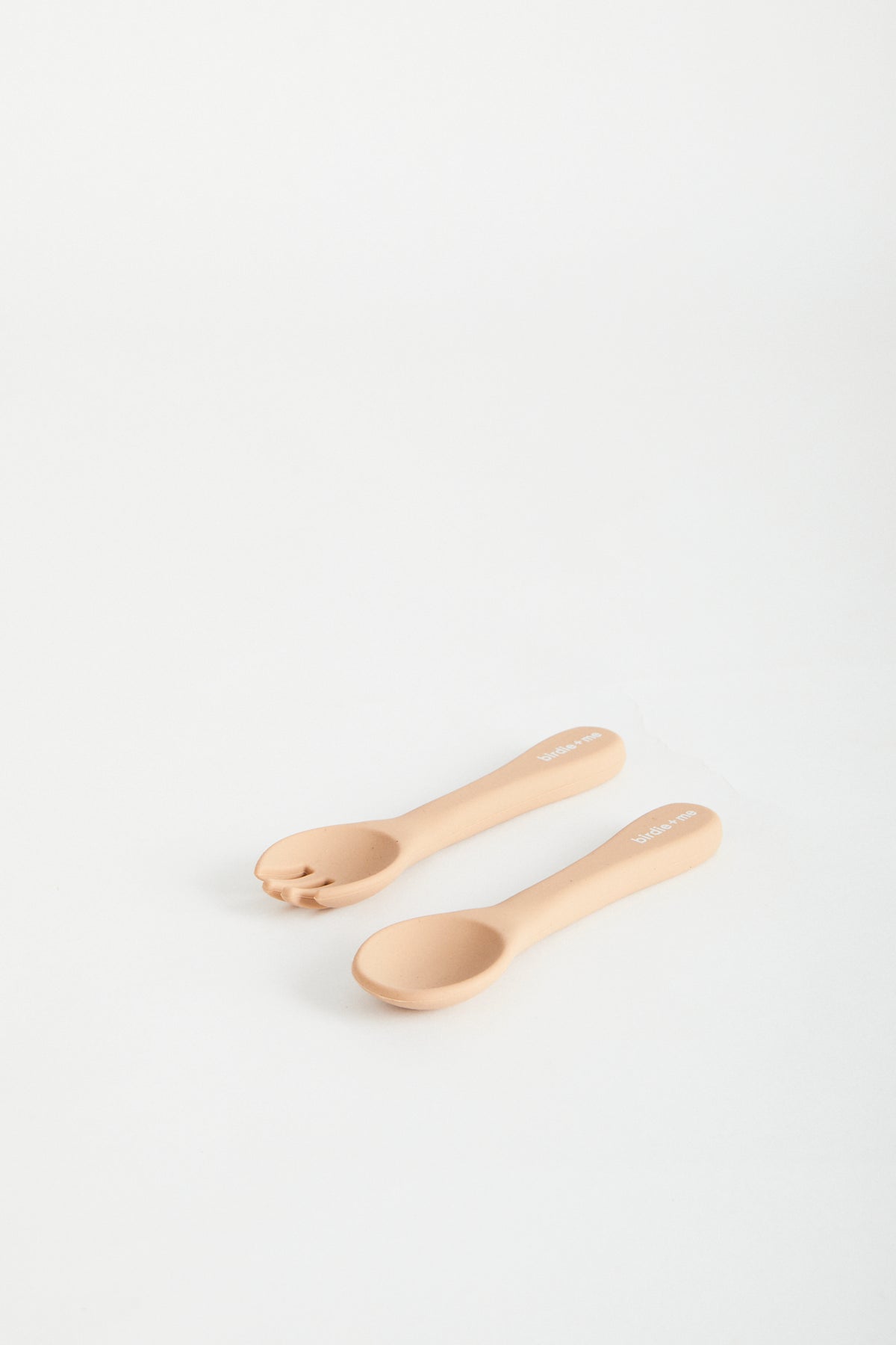 Silicon spoon & fork set in blush, birdie + me logo on handle.