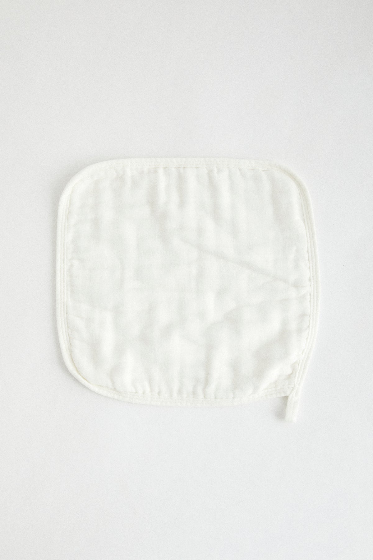 Organic muslin wash cloths in white. Set of three, wrapped in Birdie + Me branded cotton ribbon.