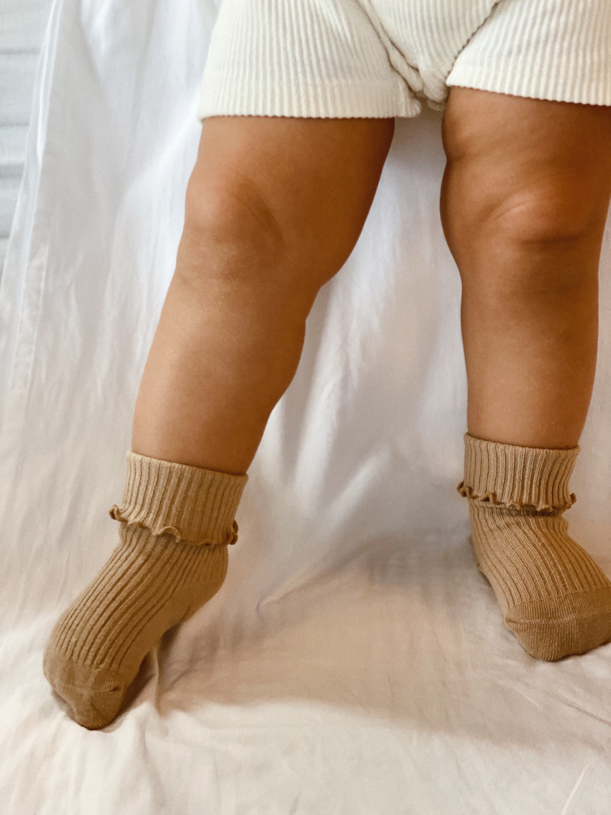 Ruffle and ribbed Socks in Sand, worn folded.