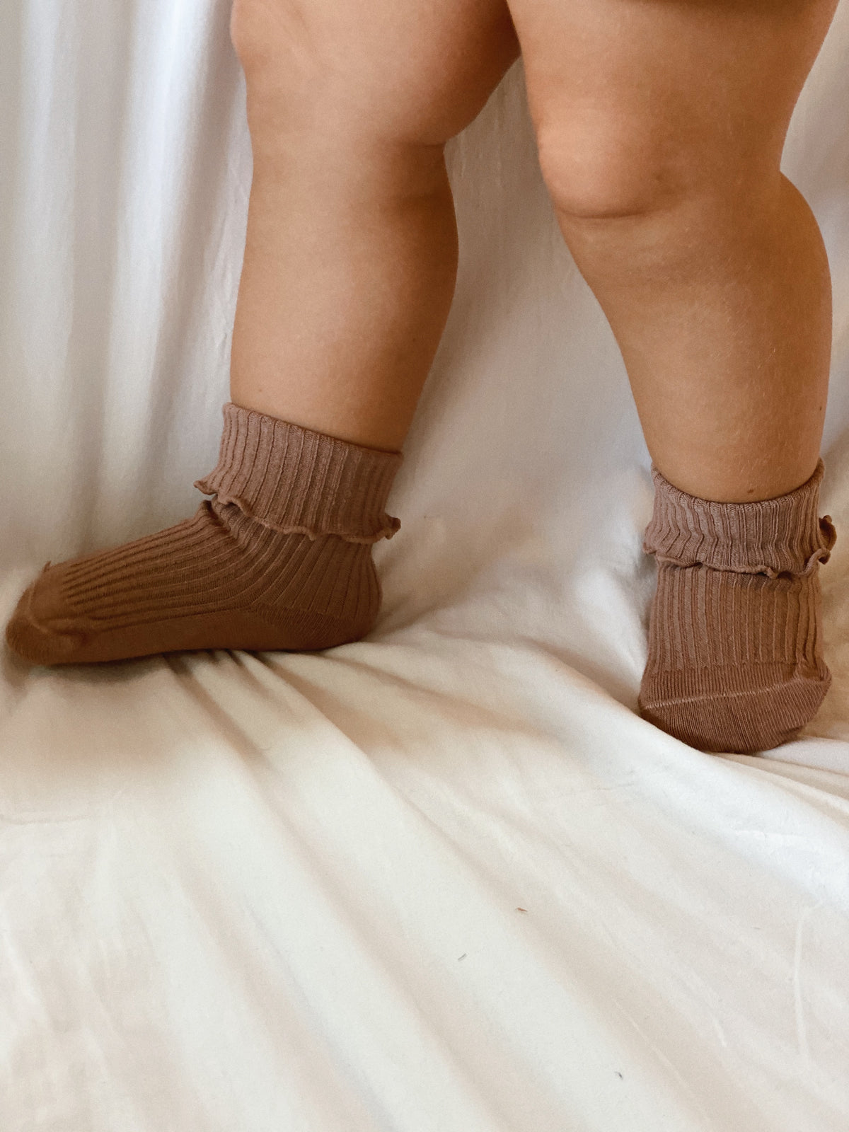 Ruffle and ribbed Socks in Dusty Pink, worn folded.