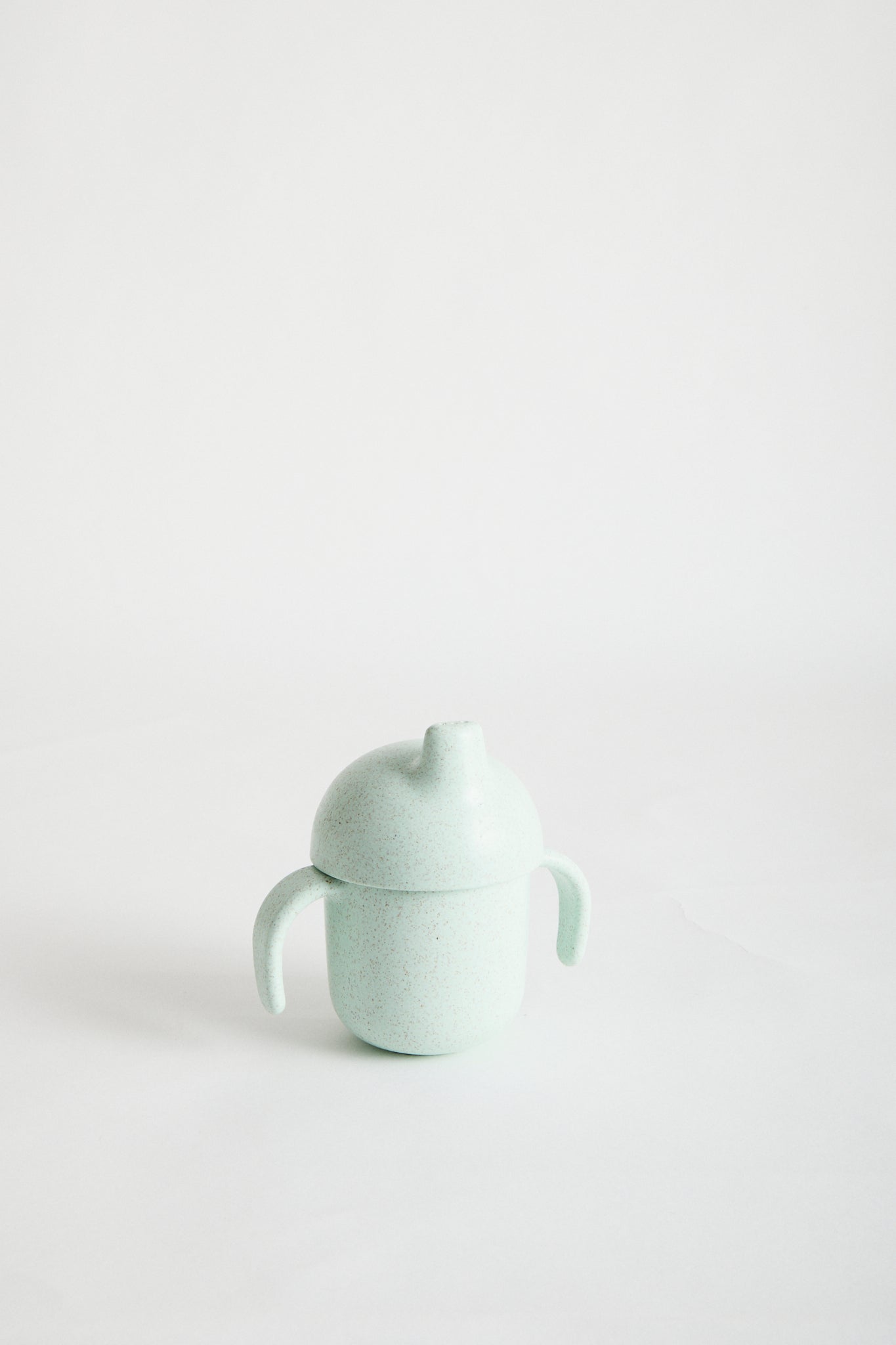 Wheat Straw Sippy Cup in Mint. White screw top lid, sappy spout and handles.