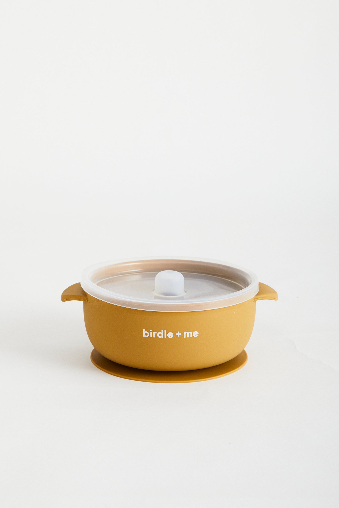 Silicone bowl with suction bottom and lid. Branded with birdie + me logo.