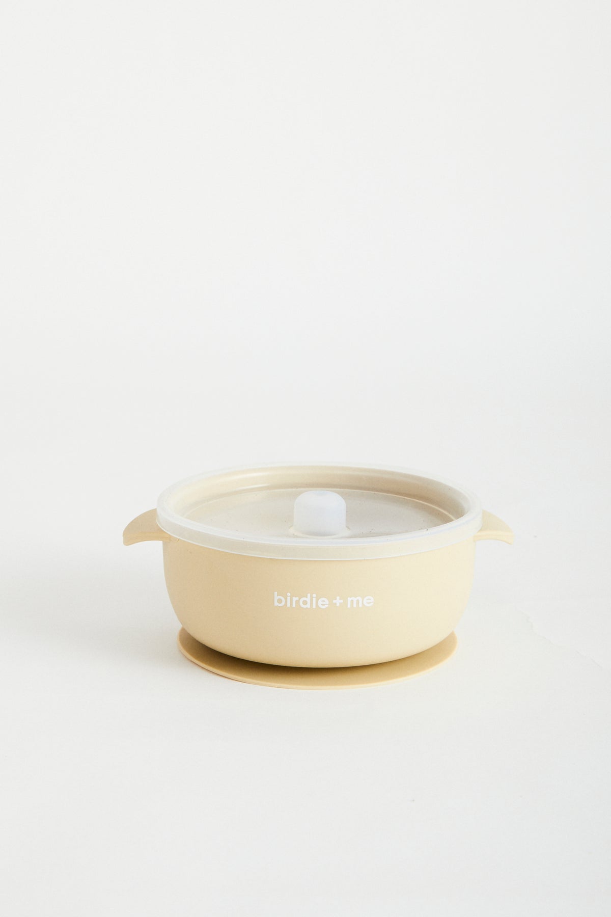 Silicone bowl with suction bottom and lid. Branded with birdie + me logo.