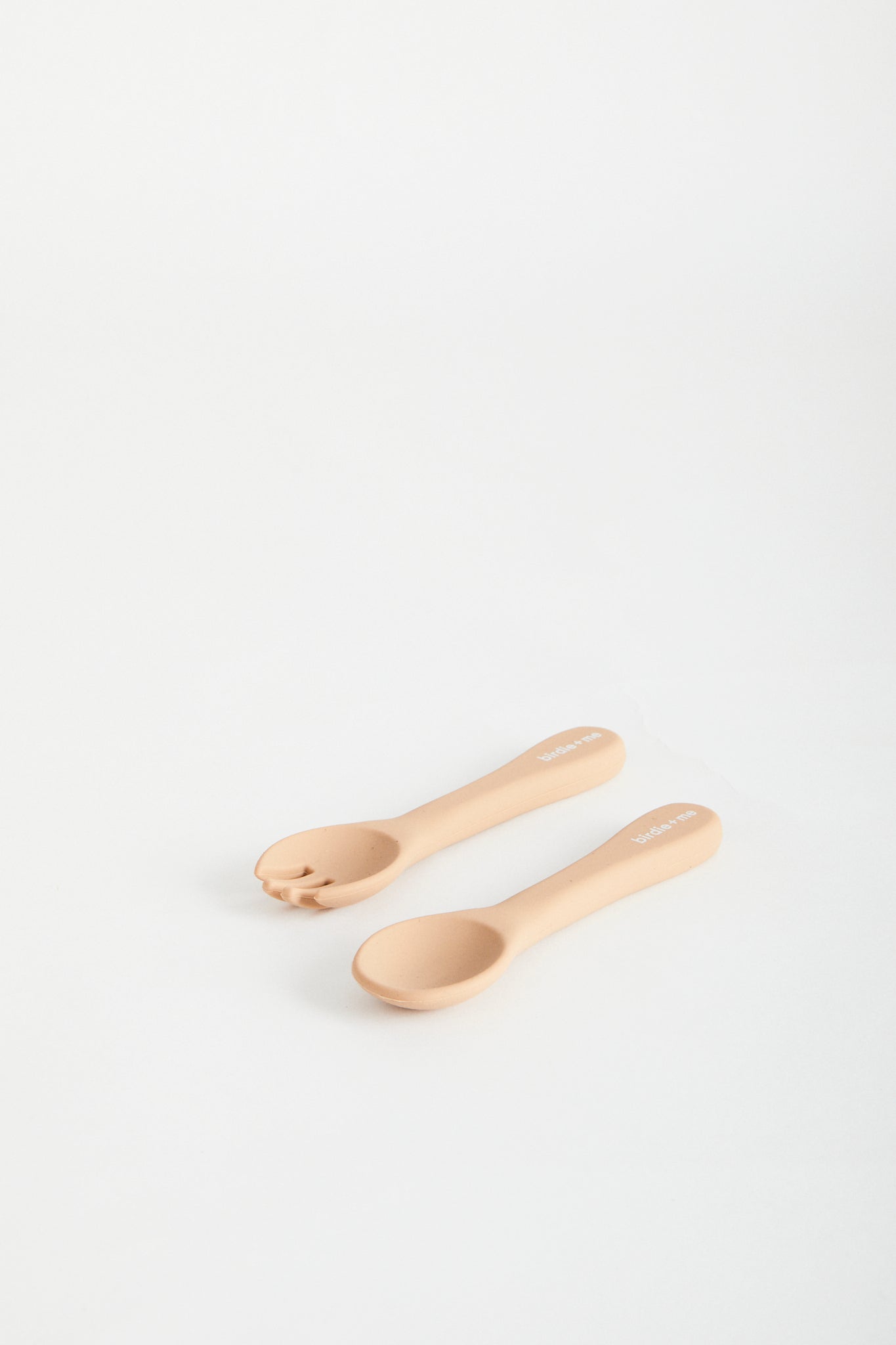 Silicon spoon & fork set in blush, birdie + me logo on handle.