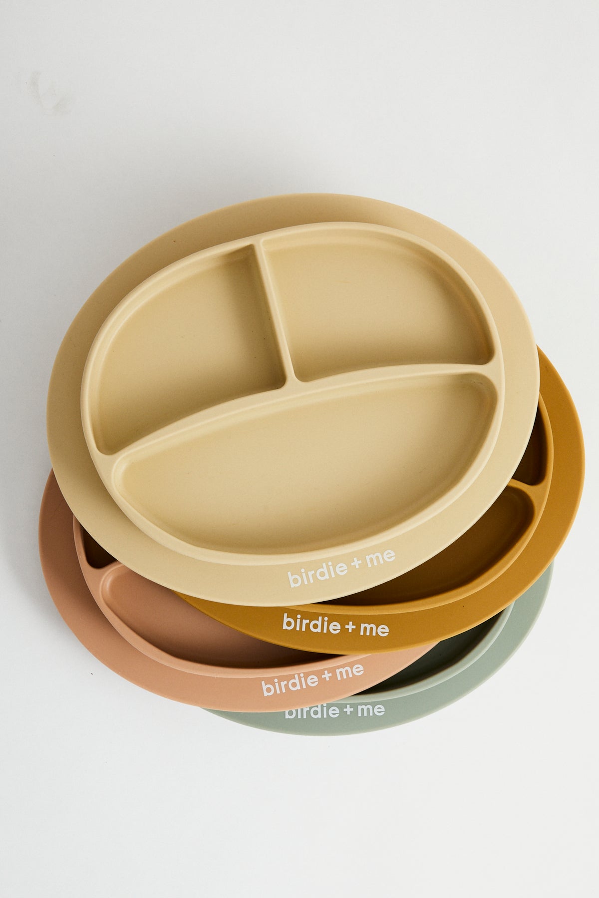Silicone suction plate in teal, honey, clay, blush. Featuring dividers and birdie + me logo.