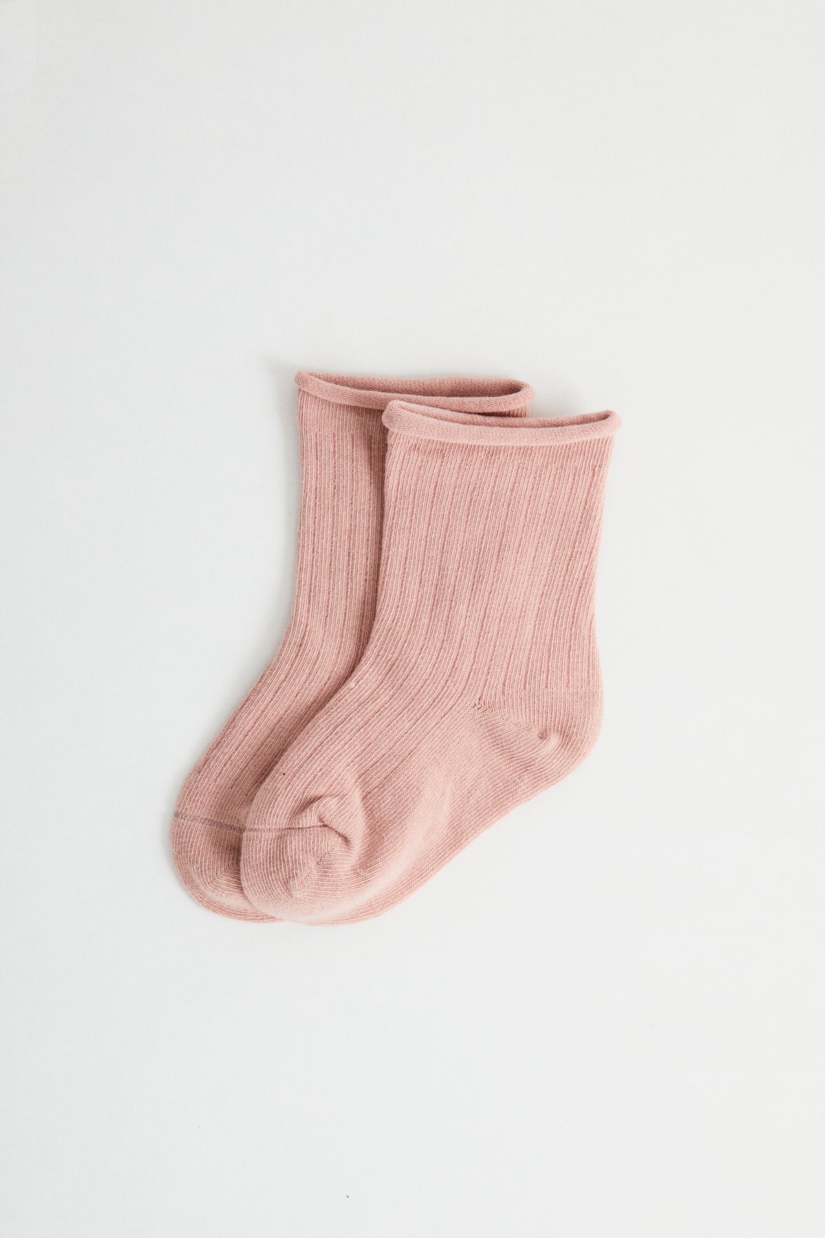 Rose coloured ribbed socks, rolled hem.