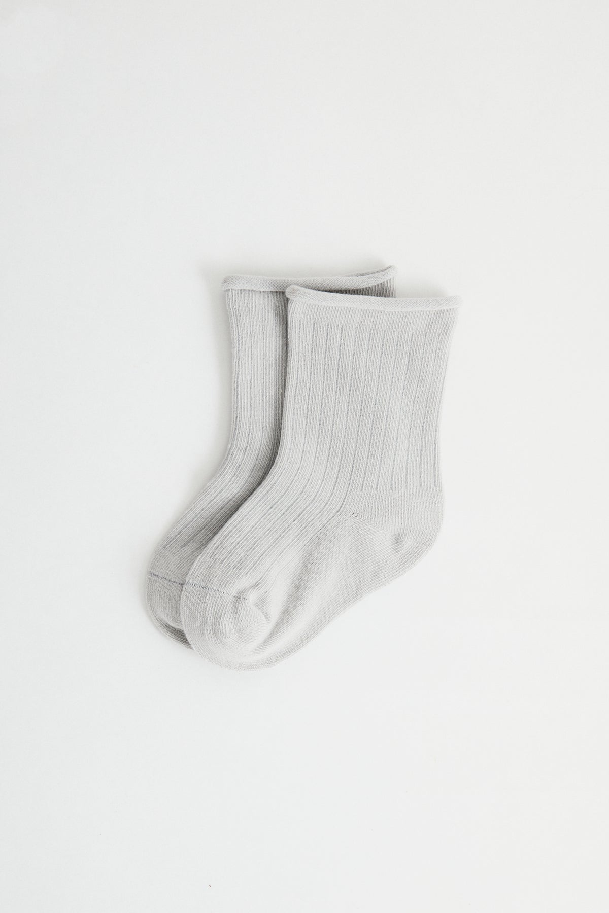 Sky coloured ribbed socks, rolled hem.