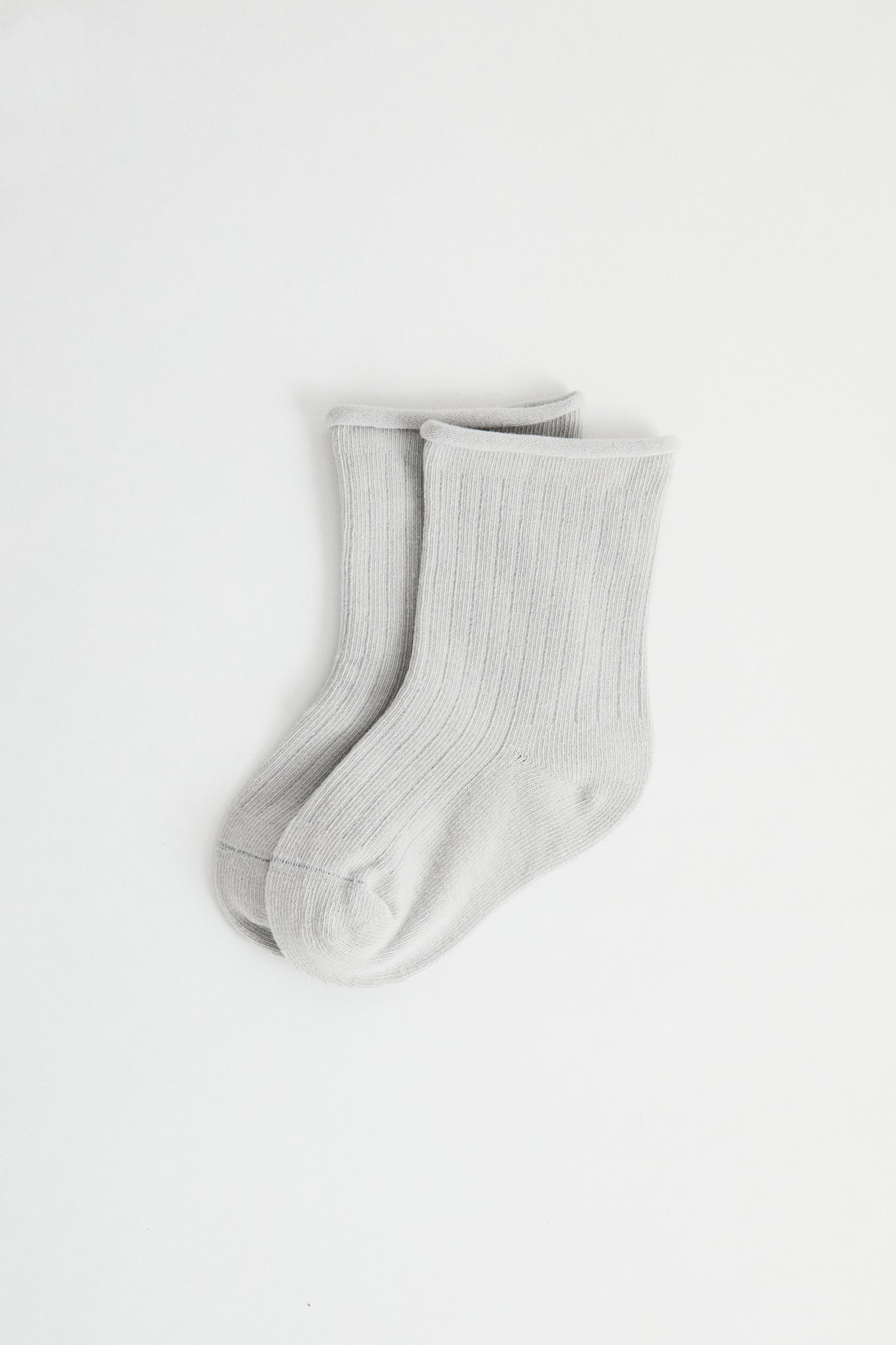 Sky coloured ribbed socks, rolled hem.
