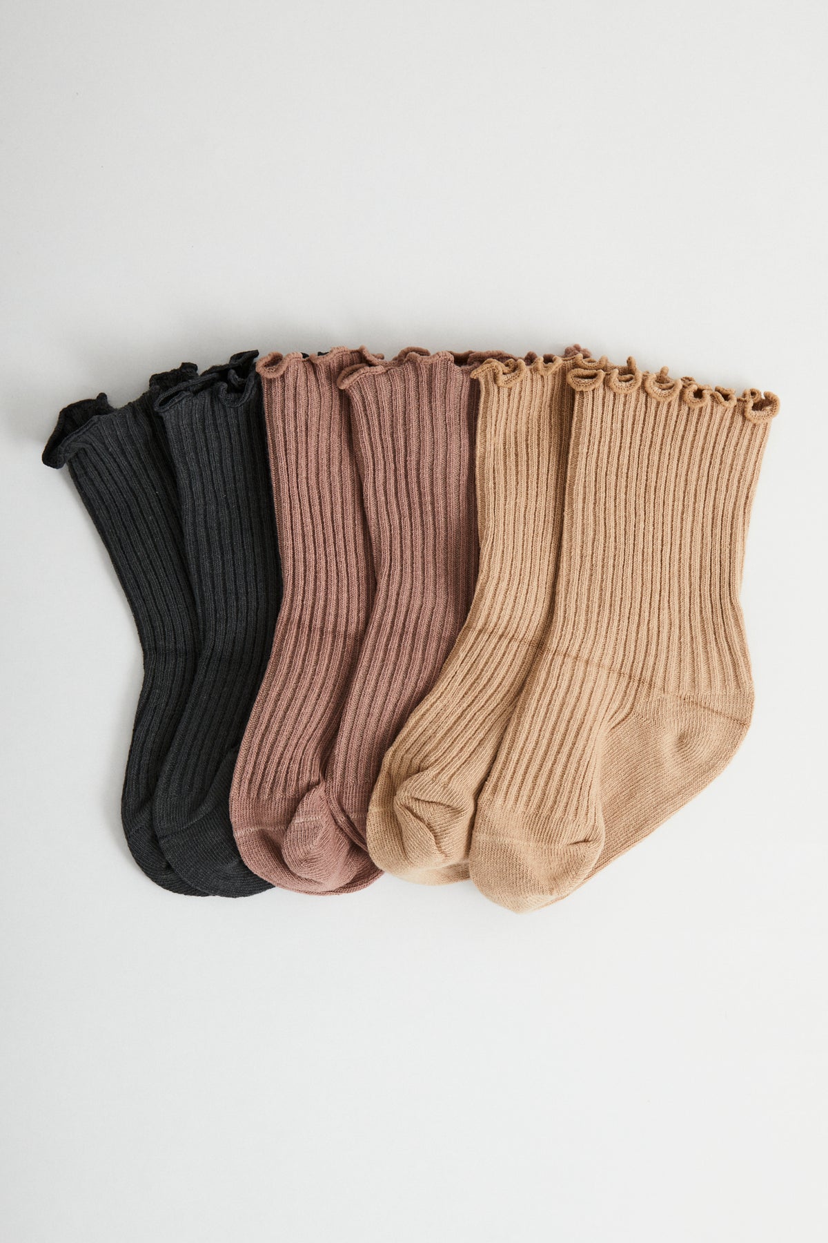 Ruffle socks come in three colours. Charcoal, Dusty Pink, Sand