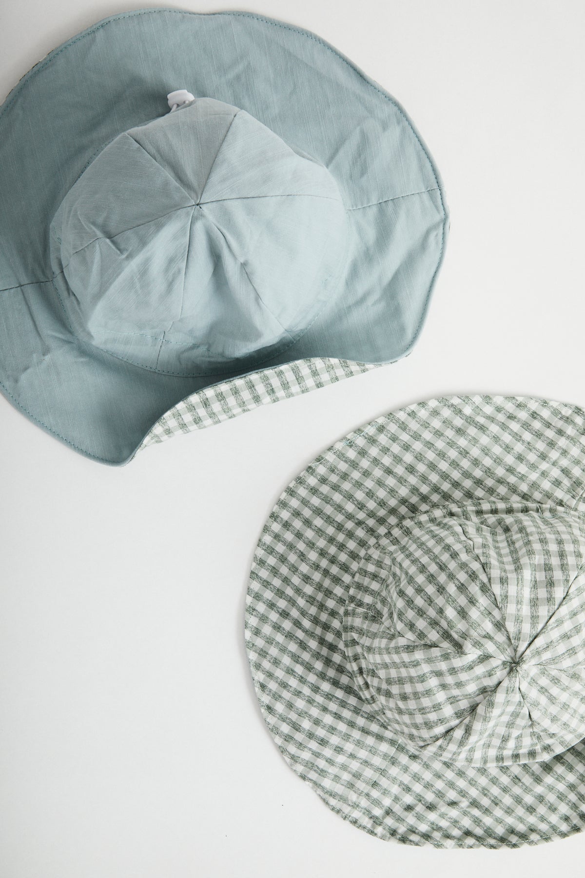 Blue Gingham reversible sun hat. Drawstring toggle and wire brim.