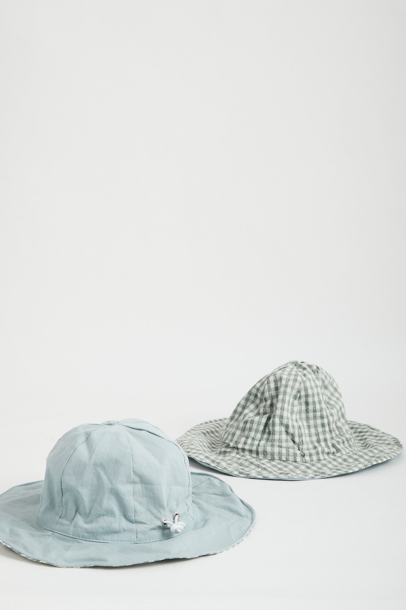 Blue Gingham reversible sun hat. Drawstring toggle and wire brim.