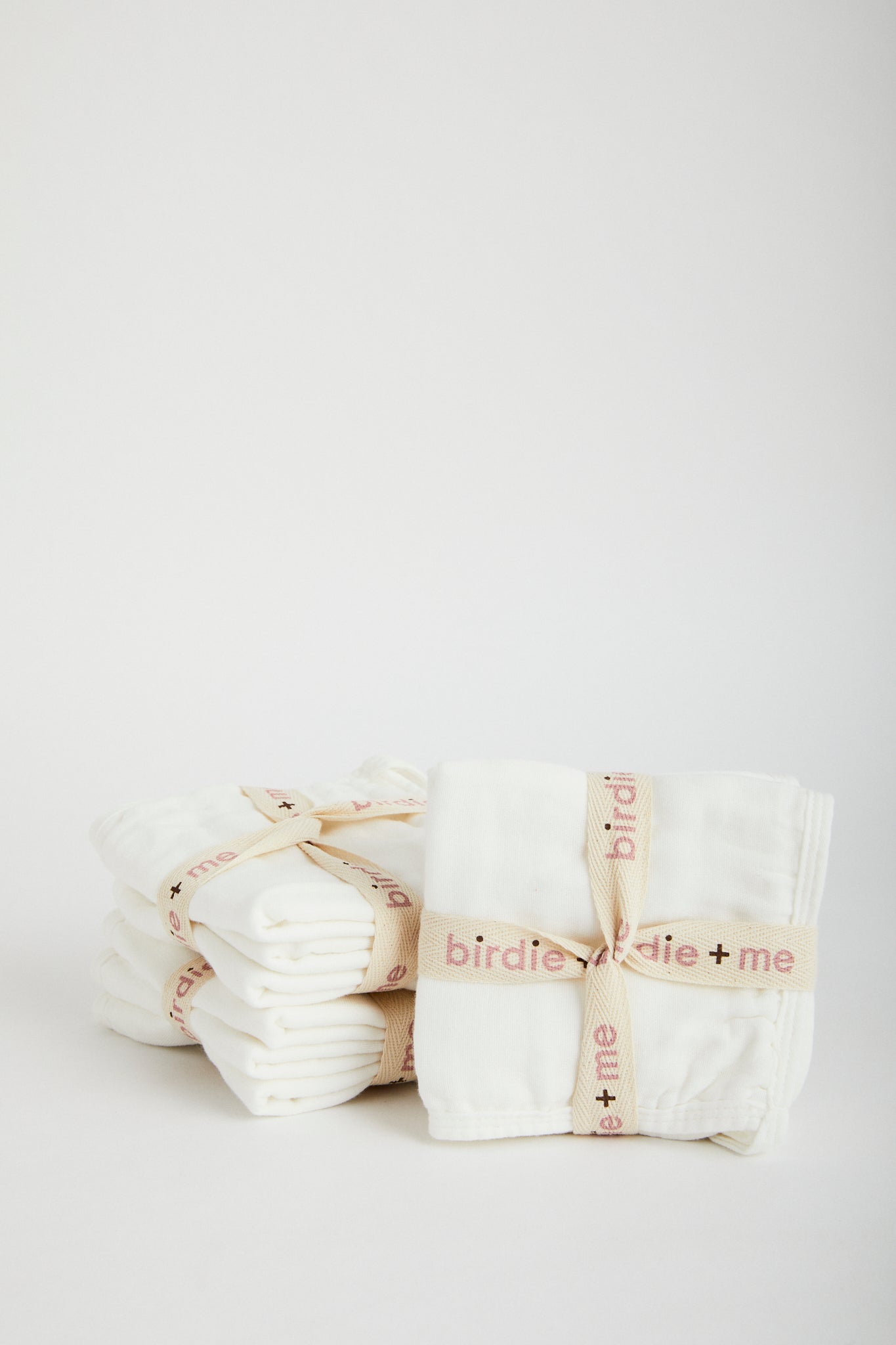 Organic muslin wash cloths in white. Set of three, wrapped in Birdie + Me branded cotton ribbon.