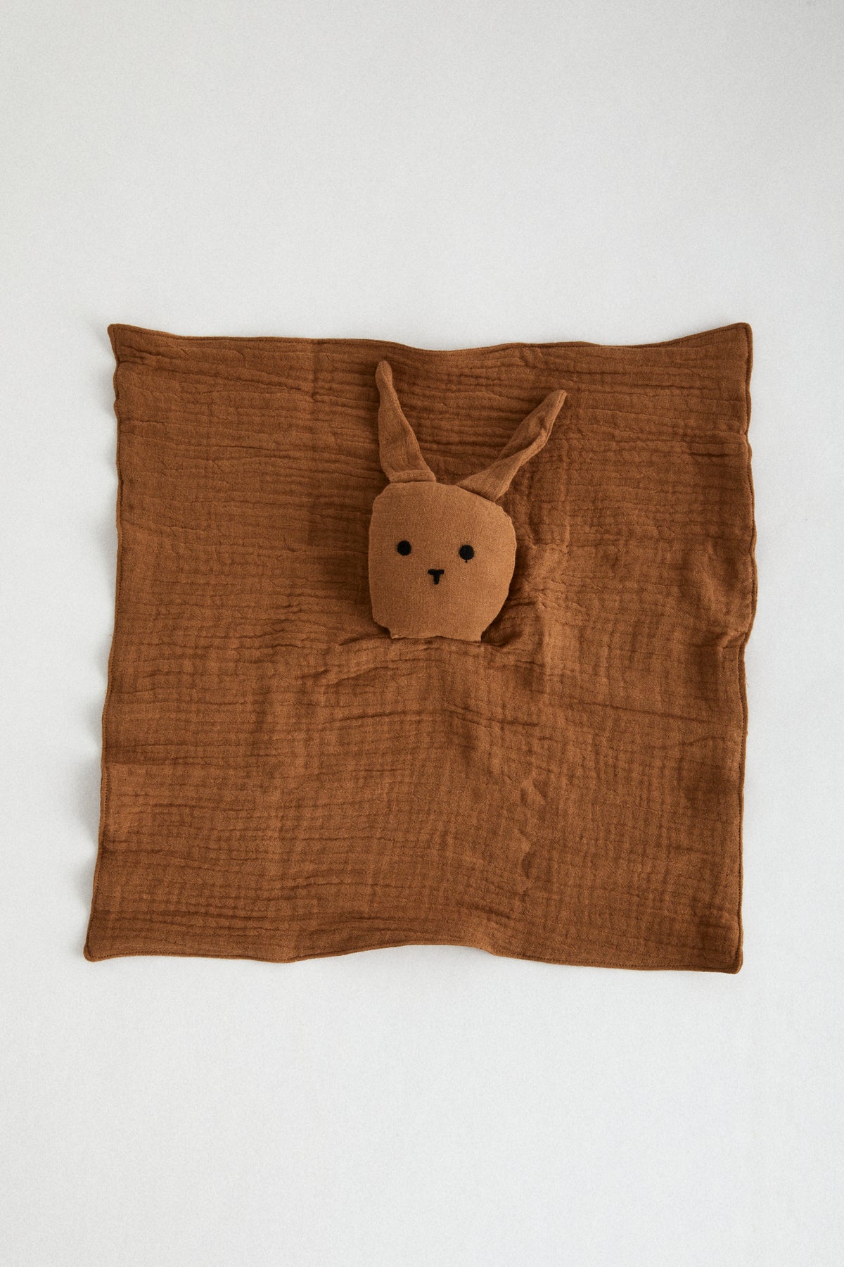 Chocolate organic muslin lovey with bunny head and floppy ears.