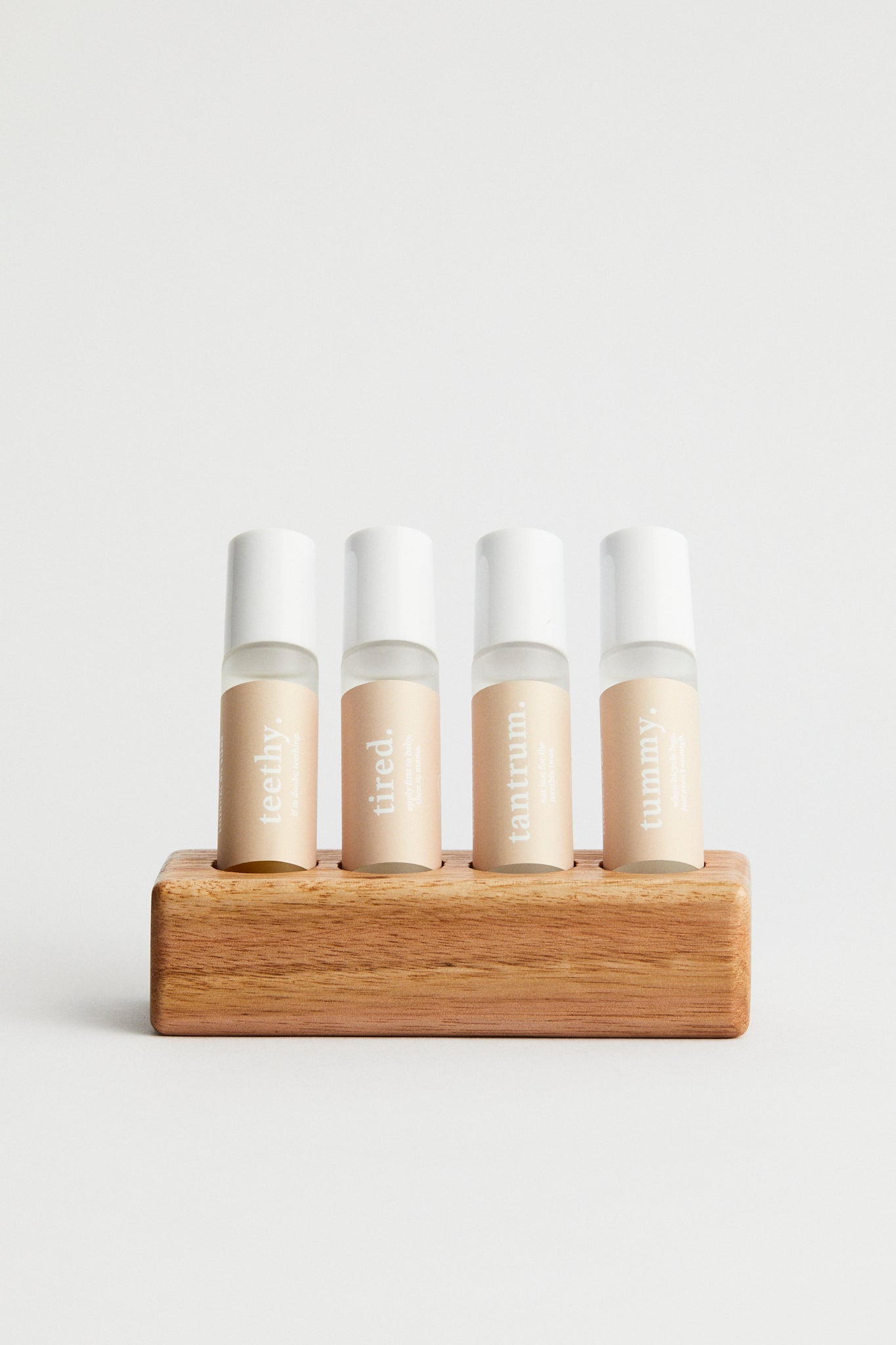 Essential oil roller bottles x 4 in wooden stand. teethy, tired, tantrum, tummy
