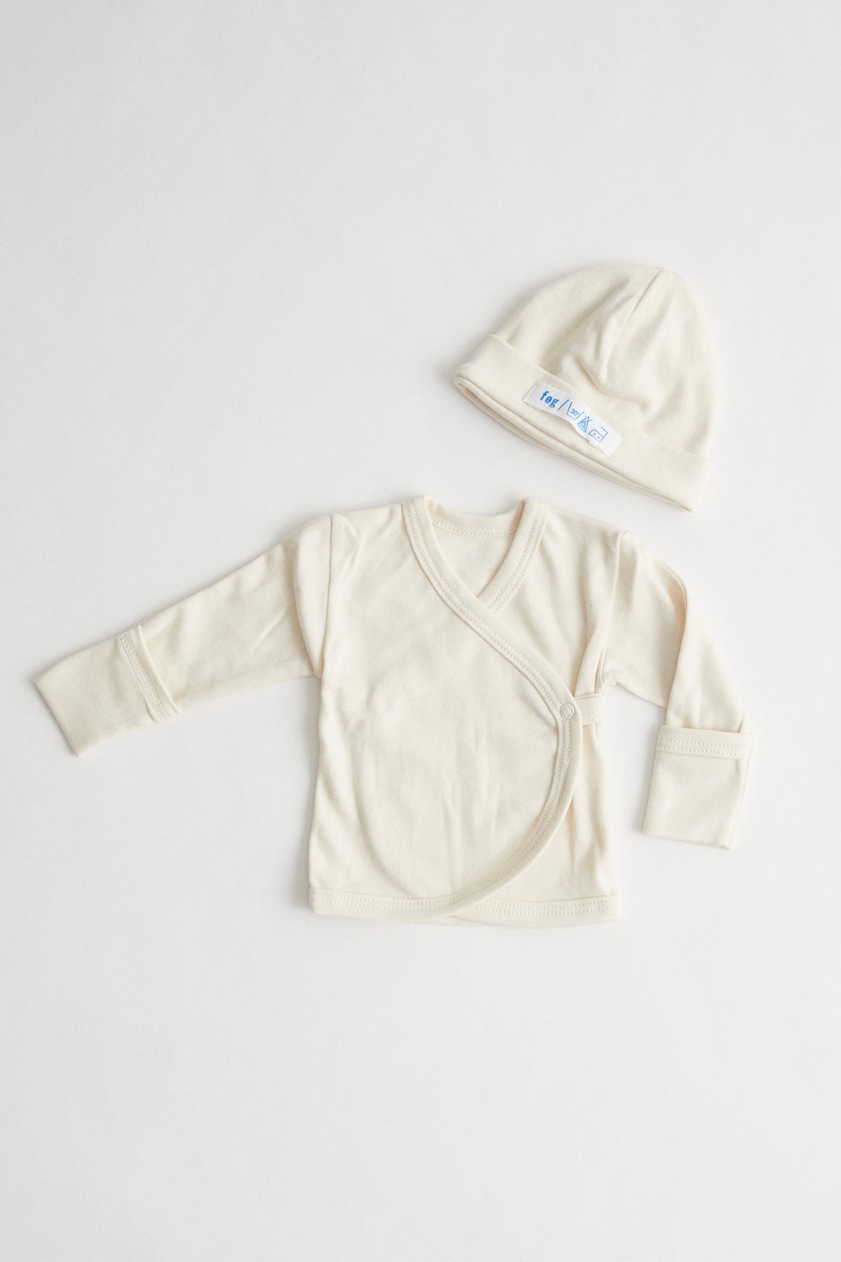 organic cotton baby kimono and beanie packaged in muslin drawstring pouch.