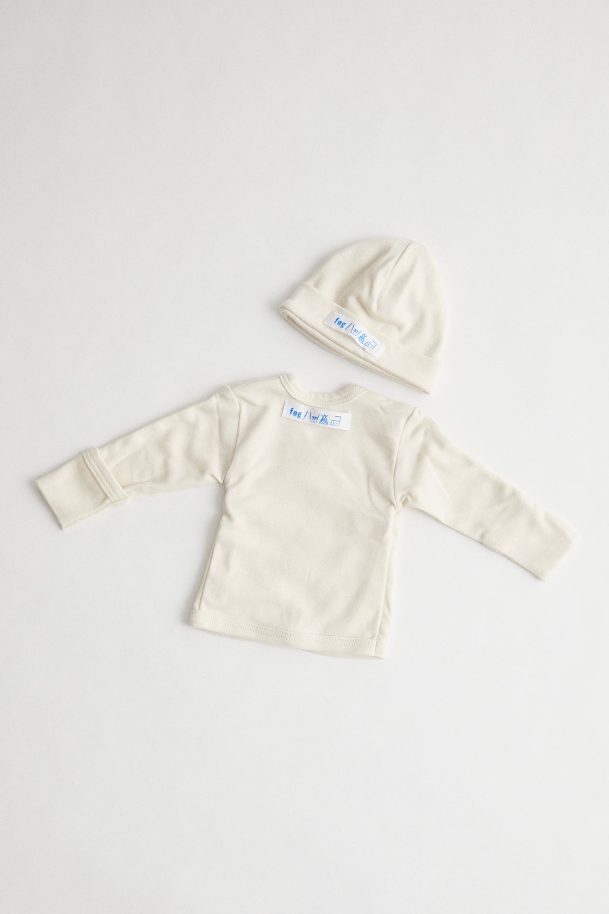 organic cotton baby kimono and beanie packaged in muslin drawstring pouch.