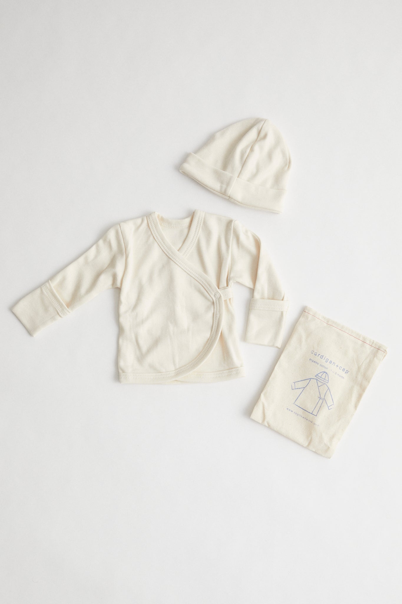 organic cotton baby kimono and beanie packaged in muslin drawstring pouch.