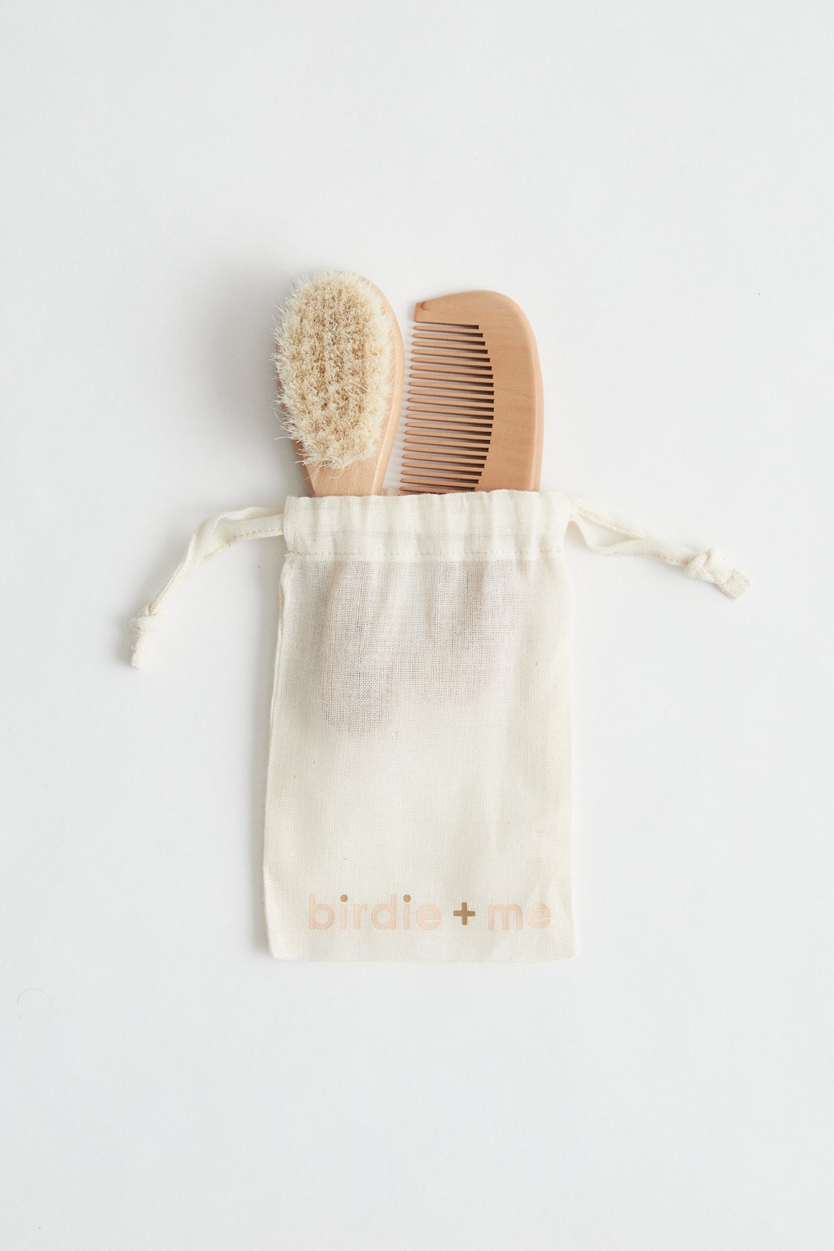baby wooden goat hair brush and comb set. b + m engraved on handles. Birdie + Me muslin bag