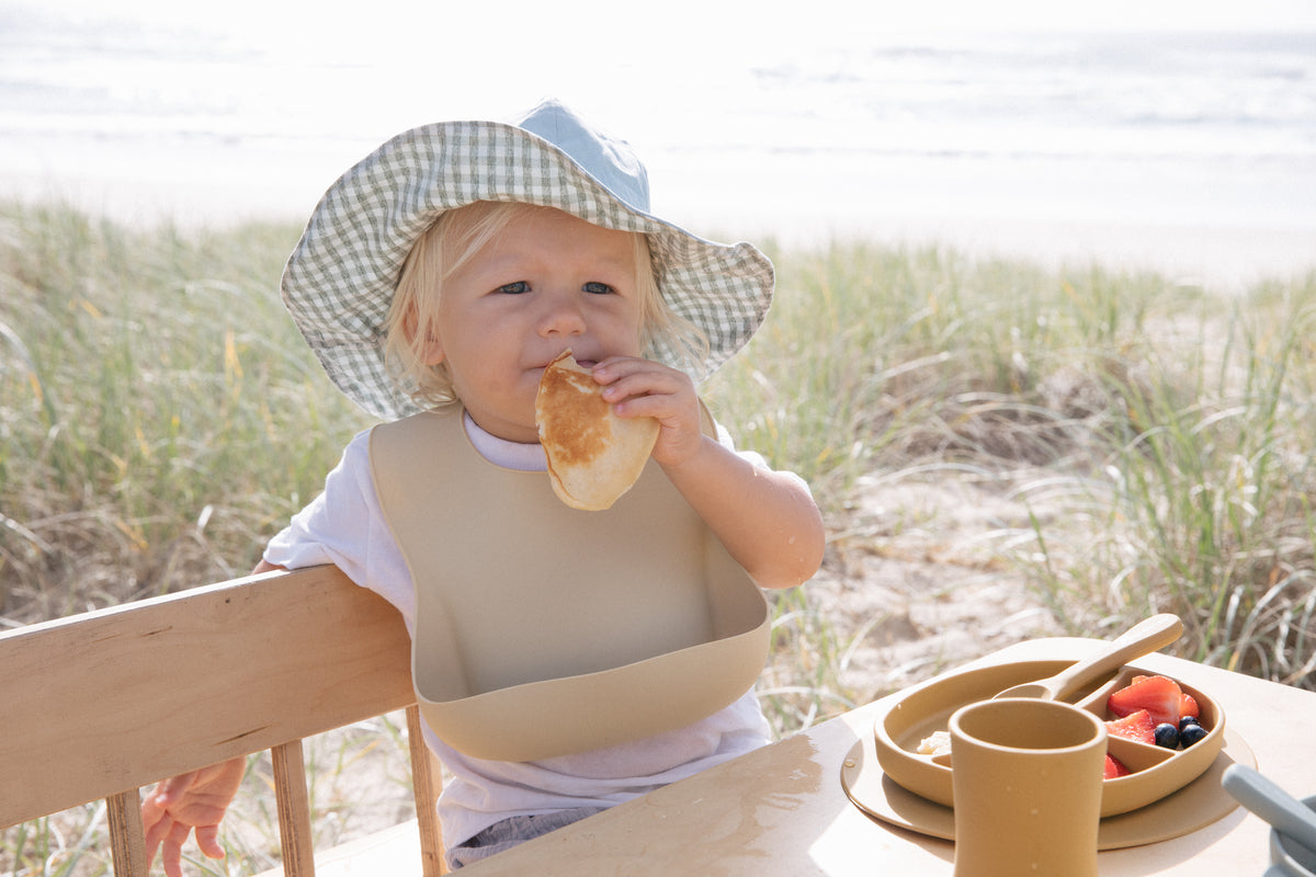 Blue Gingham reversible sun hat. Drawstring toggle and wire brim.