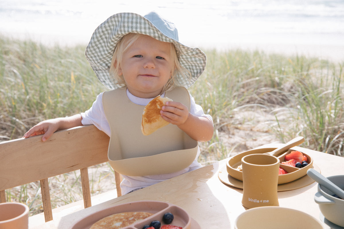 Silicone bib worn by toddler.