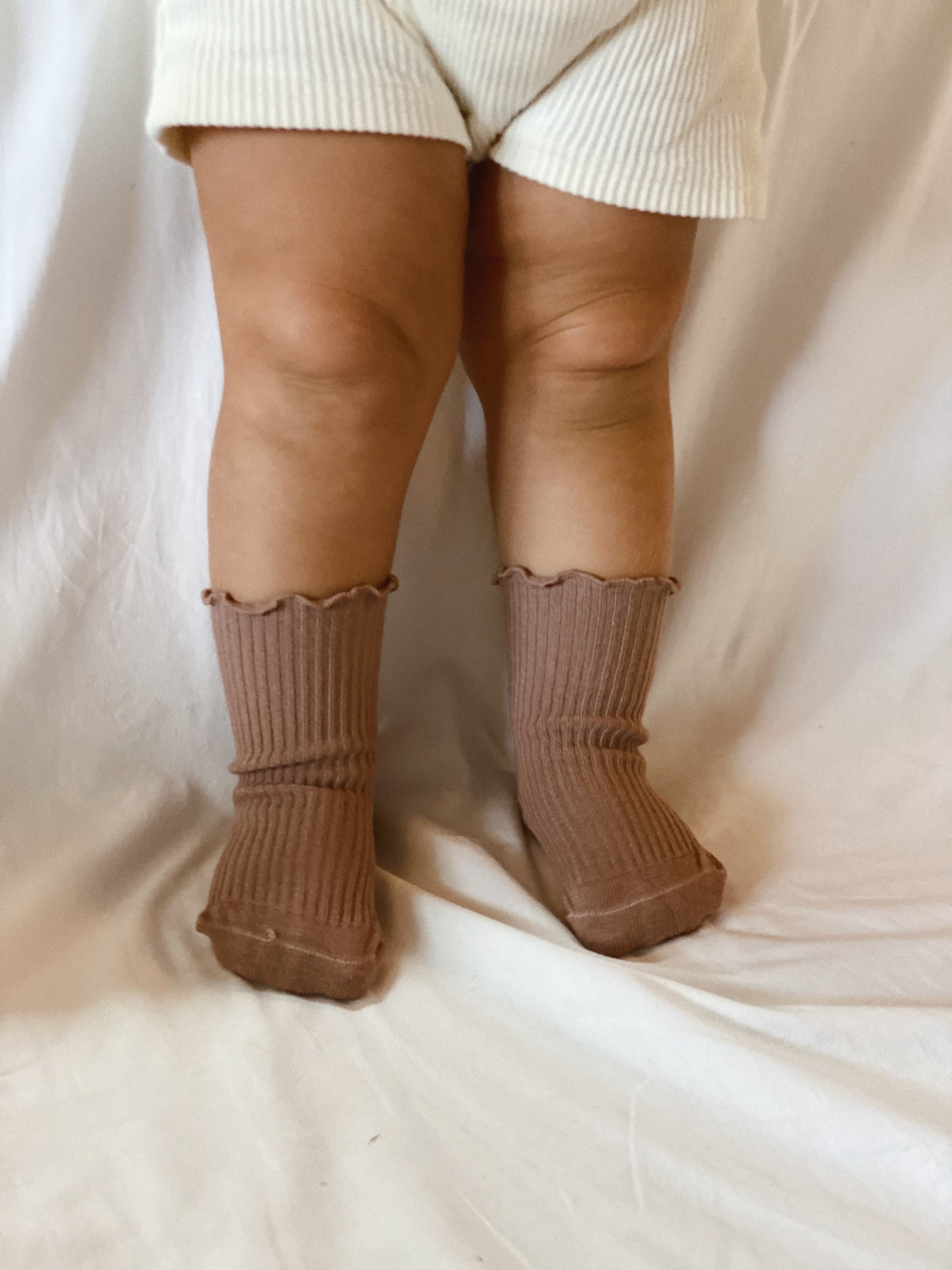 Ruffle and ribbed Socks in Dusty Pink, worn high.